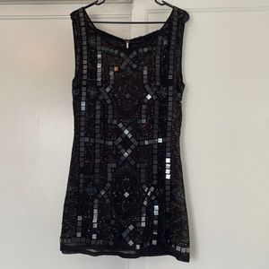 Black sequin and beaded free people dress .